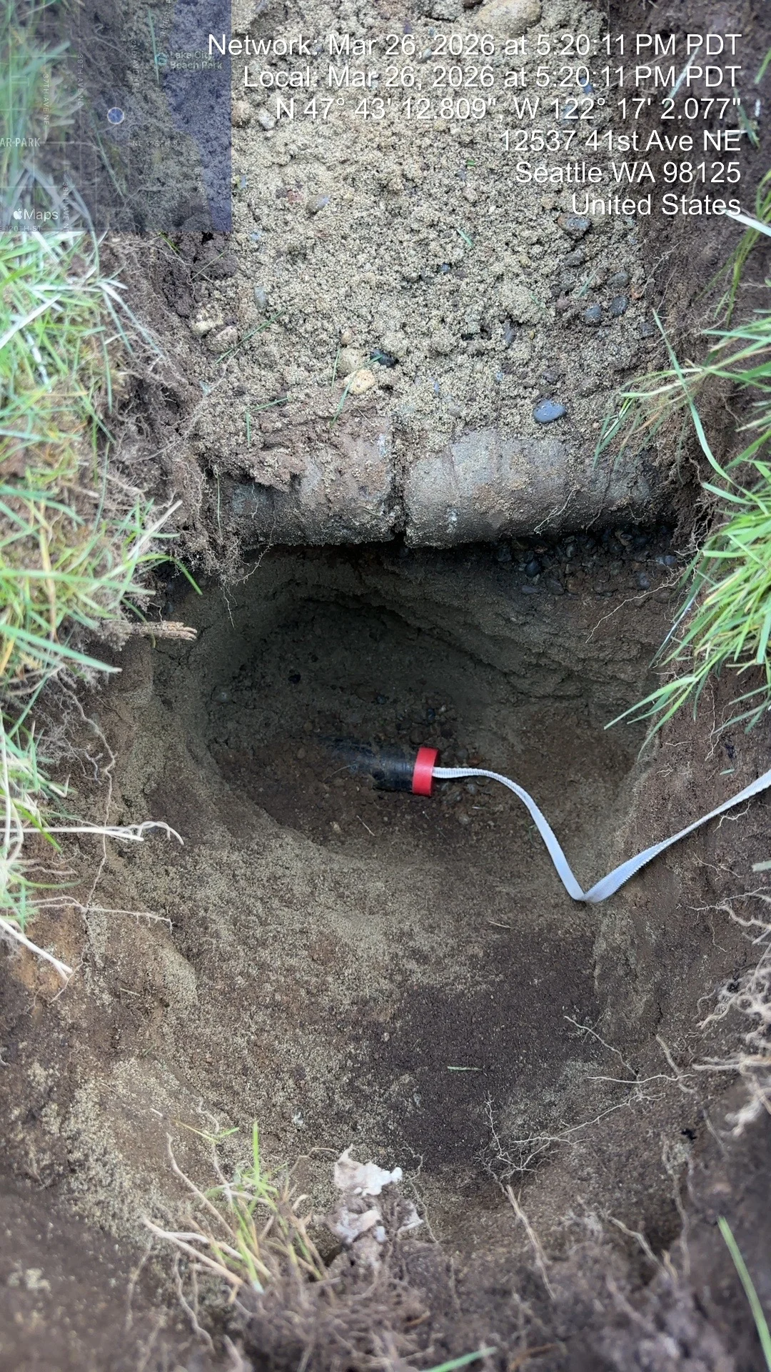 Underground utility conduit installation in excavated trench with red connector coupling