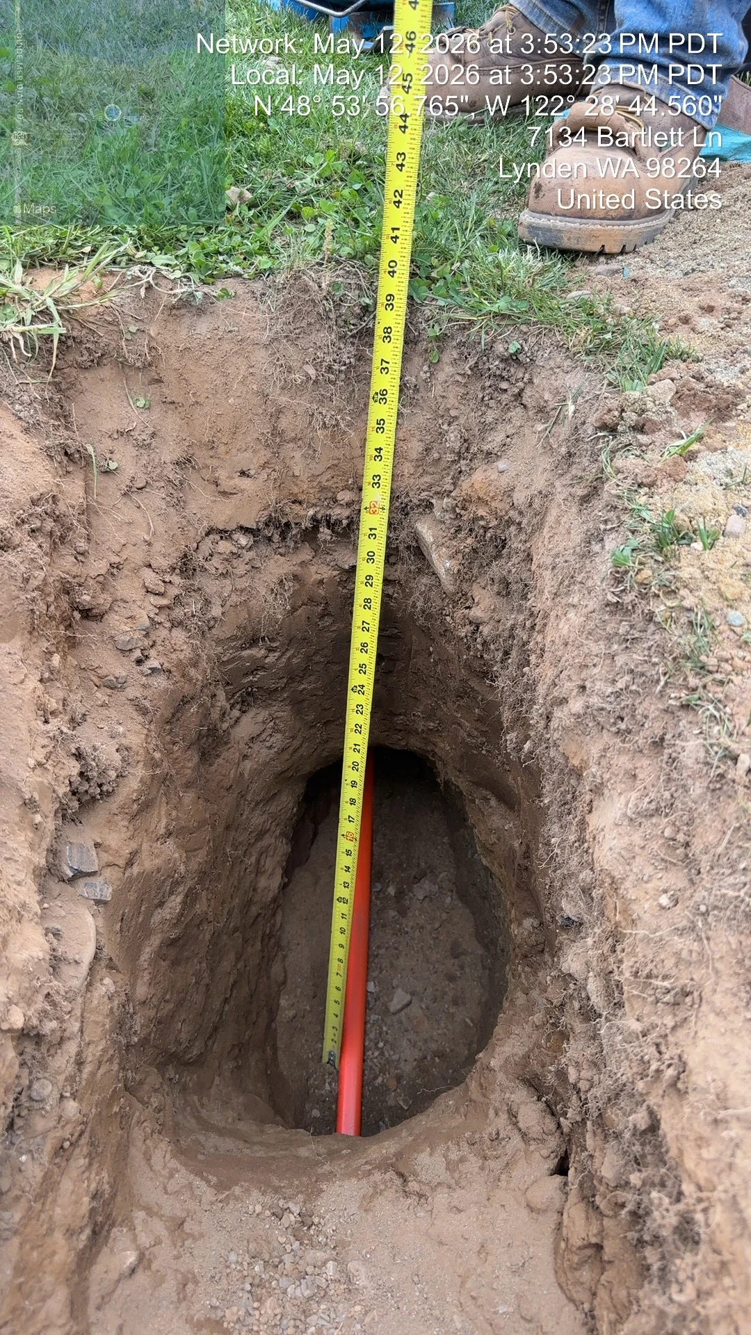 Deep utility trench with yellow tape measure showing excavation depth in Lynnden, WA